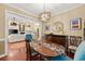 Bright dining room featuring wood floors, designer lighting, and an open floor plan to the living area at 4803 Bucks Bluff Dr., North Myrtle Beach, SC 29582