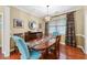 Dining room featuring wood floors, modern chandelier, and traditional furniture with natural light at 4803 Bucks Bluff Dr., North Myrtle Beach, SC 29582