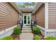 Charming front entrance with double doors, steps, and a small porch with seating at 4803 Bucks Bluff Dr., North Myrtle Beach, SC 29582