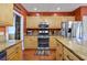 A full kitchen view with a stainless steel refrigerator, double oven, granite countertops, and hardwood flooring at 4803 Bucks Bluff Dr., North Myrtle Beach, SC 29582