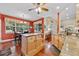 Bright eat-in kitchen featuring a center island, granite counters, hardwood floors, and stainless steel appliances at 4803 Bucks Bluff Dr., North Myrtle Beach, SC 29582