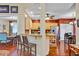 Open kitchen with granite counters, stainless appliances, breakfast bar, and hardwood floors looking into dining area at 4803 Bucks Bluff Dr., North Myrtle Beach, SC 29582