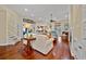 Open-concept living room with hardwood floors, large windows, and access to other living spaces at 4803 Bucks Bluff Dr., North Myrtle Beach, SC 29582