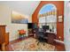 Home office with a large window, dark wood desk, and bright art on the wall at 4803 Bucks Bluff Dr., North Myrtle Beach, SC 29582