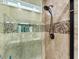 Walk-in shower with tiled walls, a showerhead, and built-in shelving for toiletries at 4803 Bucks Bluff Dr., North Myrtle Beach, SC 29582