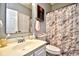 Well-lit bathroom featuring a marble-patterned shower curtain, white sink, and matching cabinet at 4811 Innisbrook Ct. # 306, Myrtle Beach, SC 29579