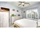Serene bedroom featuring a large window, light gray walls, and a ceiling fan for optimal comfort and relaxation at 4811 Innisbrook Ct. # 306, Myrtle Beach, SC 29579