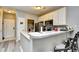 Bright kitchen with a breakfast bar, white cabinets, stainless steel appliances, and durable countertop space at 4811 Innisbrook Ct. # 306, Myrtle Beach, SC 29579