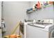 Modern laundry room featuring a washer and dryer set with an iron and shelving at 4811 Innisbrook Ct. # 306, Myrtle Beach, SC 29579