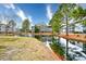 Scenic view of a pond, fountain, and condo buildings surrounded by mature trees at 4811 Innisbrook Ct. # 306, Myrtle Beach, SC 29579