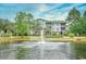Scenic pond view with a fountain and condo buildings surrounded by lush greenery at 4811 Innisbrook Ct. # 306, Myrtle Beach, SC 29579
