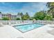 Community pool, surrounded by lounge chairs and a white fence, offers a tranquil outdoor space at 4811 Innisbrook Ct. # 306, Myrtle Beach, SC 29579