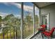 Cozy screened porch featuring a view of nature, a patio table and chairs, and exterior access at 4811 Innisbrook Ct. # 306, Myrtle Beach, SC 29579