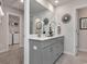 A bathroom with a double vanity with gray cabinetry, white countertop and stainless steel faucets at 4861 Hopespring St., Myrtle Beach, SC 29579