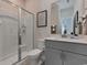 Bathroom featuring a toilet, shower and vanity with gray cabinets and white countertop at 4861 Hopespring St., Myrtle Beach, SC 29579