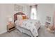 Bedroom with a bed covered in rainbow patterned covers, a nightstand, and a matching window treatment at 4861 Hopespring St., Myrtle Beach, SC 29579