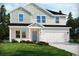 Charming two-story home featuring a large front yard, a two-car garage, and eye-catching architectural details at 4861 Hopespring St., Myrtle Beach, SC 29579