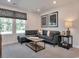 Cozy living room with a comfortable sofa, patterned window shade, artwork, and soft lighting for a relaxing atmosphere at 4861 Hopespring St., Myrtle Beach, SC 29579
