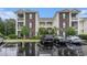 A multi-story condo building with brick and white siding, balconies, and parking at 488 River Oaks Dr. # 61N, Myrtle Beach, SC 29579