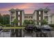Condo buildings in the parking lot on a rainy day with a colorful sunset at 488 River Oaks Dr. # 61N, Myrtle Beach, SC 29579