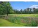Scenic view of a lush golf course with green fairways and wooded areas under a blue sky at 488 River Oaks Dr. # 61N, Myrtle Beach, SC 29579