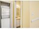 Hallway with a washer/dryer closet and a glimpse into the adjacent bathroom at 488 River Oaks Dr. # 61N, Myrtle Beach, SC 29579