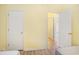 Bedroom with two white doors and view into a hallway at 488 River Oaks Dr. # 61N, Myrtle Beach, SC 29579