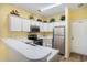 Bright kitchen features stainless steel appliances, white cabinetry, and ample counter space at 488 River Oaks Dr. # 61N, Myrtle Beach, SC 29579