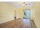 Bright living room features new wood flooring, sliding glass doors, and a ceiling fan at 488 River Oaks Dr. # 61N, Myrtle Beach, SC 29579