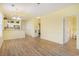 Open-concept living area flows into a kitchen; features include light wood flooring and paint at 488 River Oaks Dr. # 61N, Myrtle Beach, SC 29579