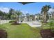 Community swimming pool and hot tub surrounded by palm trees and chairs at 488 River Oaks Dr. # 61N, Myrtle Beach, SC 29579