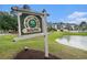 Sign at the River Oaks Golf & Tennis Resort II South entrance next to a scenic pond at 488 River Oaks Dr. # 61N, Myrtle Beach, SC 29579