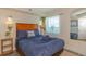 Cozy bedroom featuring a queen-sized bed with modern decor and a view at 504 N Ocean Blvd. # 1711, Myrtle Beach, SC 29577