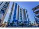 Exterior shot of condominiums featuring blue accents, multiple stories, and private balconies at 504 N Ocean Blvd. # 1711, Myrtle Beach, SC 29577