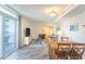 Bright living area with sliding glass doors to a balcony, dining table, and comfortable seating at 504 N Ocean Blvd. # 1711, Myrtle Beach, SC 29577