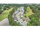 Aerial view showcasing a golf course community with winding roads, water features, and lush greenery at 511 Colonial Trace Dr. # 7-C, Longs, SC 29568