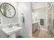 Stylish bathroom with modern fixtures, a vessel sink, and a framed round mirror at 511 Colonial Trace Dr. # 7-C, Longs, SC 29568