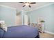 Inviting bedroom with wood flooring, a ceiling fan, and light blue walls at 511 Colonial Trace Dr. # 7-C, Longs, SC 29568