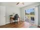 Well-lit bedroom showcasing wood floors and a sliding door to the outdoor patio area at 511 Colonial Trace Dr. # 7-C, Longs, SC 29568