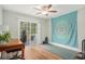 Bright, airy bedroom with a ceiling fan, desk, and sliding door to the patio at 511 Colonial Trace Dr. # 7-C, Longs, SC 29568