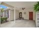 The carport features a ceiling fan, two doors, and a decorative clock against a neutral color scheme at 511 Colonial Trace Dr. # 7-C, Longs, SC 29568