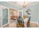 Cozy dining room featuring a chandelier, and glass doors leading to the sunroom at 511 Colonial Trace Dr. # 7-C, Longs, SC 29568