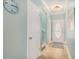 The foyer features a decorative front door, wood-look floors, and serene light blue walls at 511 Colonial Trace Dr. # 7-C, Longs, SC 29568