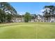 Beautiful golf course with a manicured green and a view of surrounding homes at 511 Colonial Trace Dr. # 7-C, Longs, SC 29568