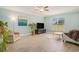 Bright living room featuring wood-look floors, a ceiling fan, and a large window overlooking the outdoors at 511 Colonial Trace Dr. # 7-C, Longs, SC 29568