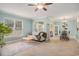 An open-concept living room and dining area with light blue walls, wood-look floors, and natural light at 511 Colonial Trace Dr. # 7-C, Longs, SC 29568