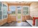 Cozy sunroom featuring a tile floor, a sofa and three large windows with a view of the outdoors at 511 Colonial Trace Dr. # 7-C, Longs, SC 29568