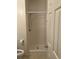 Bathroom featuring a shower, toilet and toilet paper holder next to a door at 5206 Sweetwater Blvd. # 5206, Murrells Inlet, SC 29576
