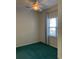 This bedroom features green carpet, a ceiling fan, and a window at 5206 Sweetwater Blvd. # 5206, Murrells Inlet, SC 29576