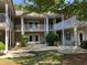 Charming condo exterior showcasing private balconies with white railings and landscaped courtyard at 5206 Sweetwater Blvd. # 5206, Murrells Inlet, SC 29576
